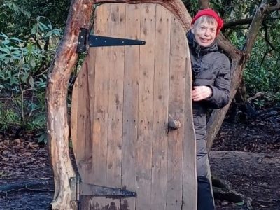 Picture of Helen Jackson coming out of a woodland doorwar