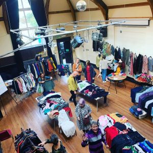 Lancaster Clothes Swap at the Gregson - room full of clothes and people browsing