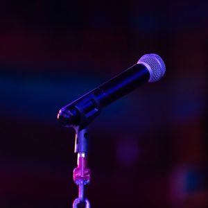 Image of microphone on a dark stage