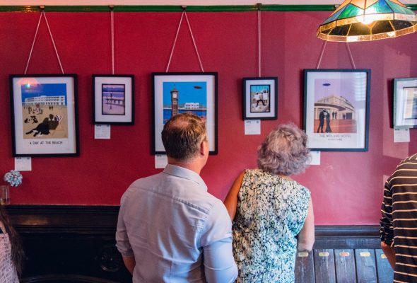 People looking at an art exhibition in the Gregson cafe/bar