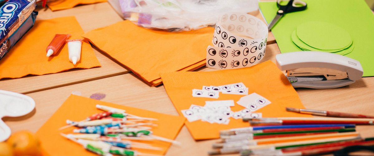 Image of children's craft materials inc paper, scissors, paint brushes and more