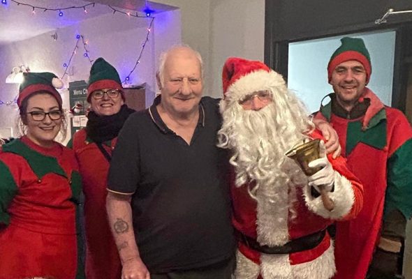 Volunteers dressed as elves and Father Christmas
