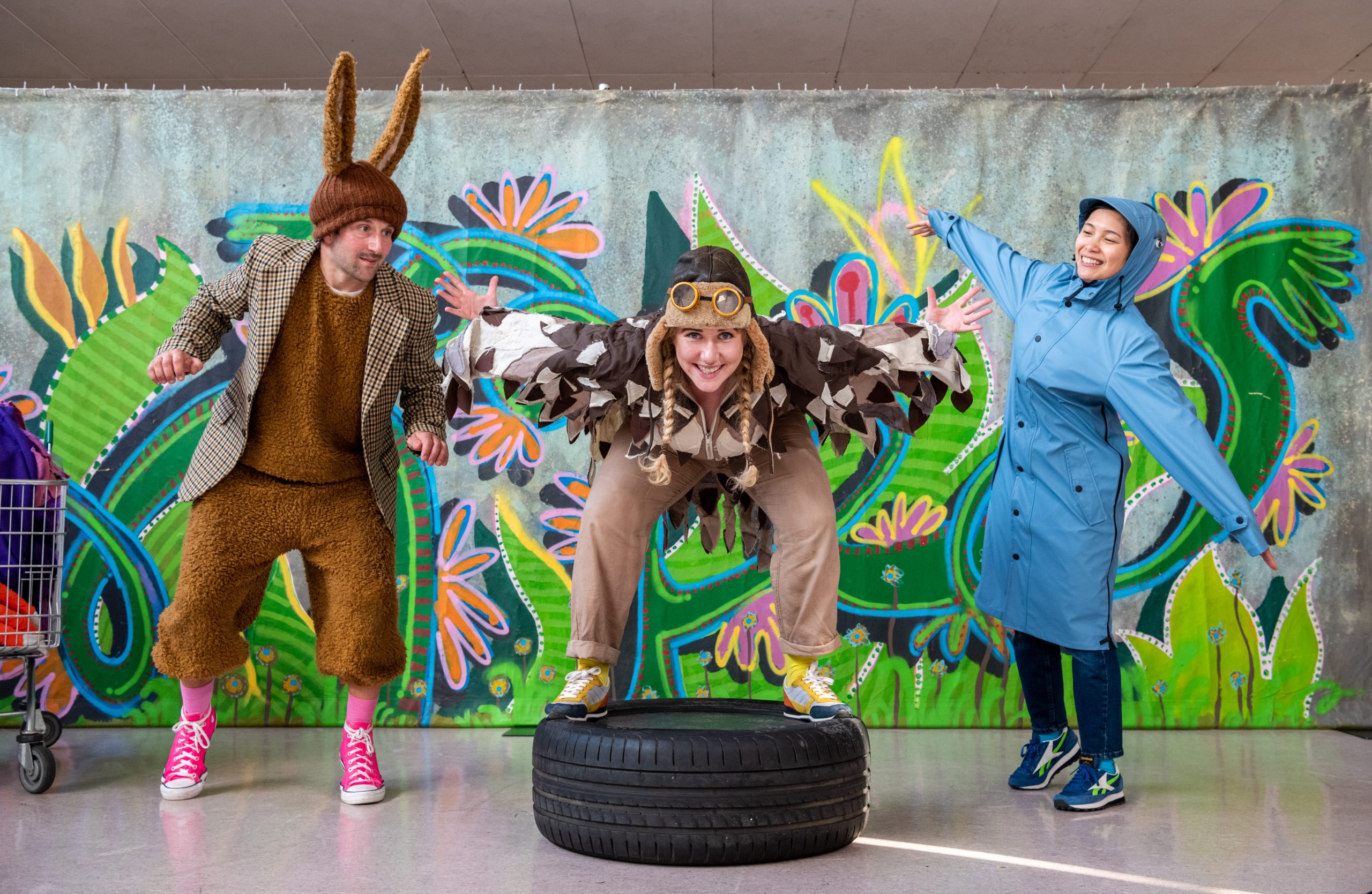 Image of theatre company Dens and Signals - a Rabbit, owl and woman in a blue coat