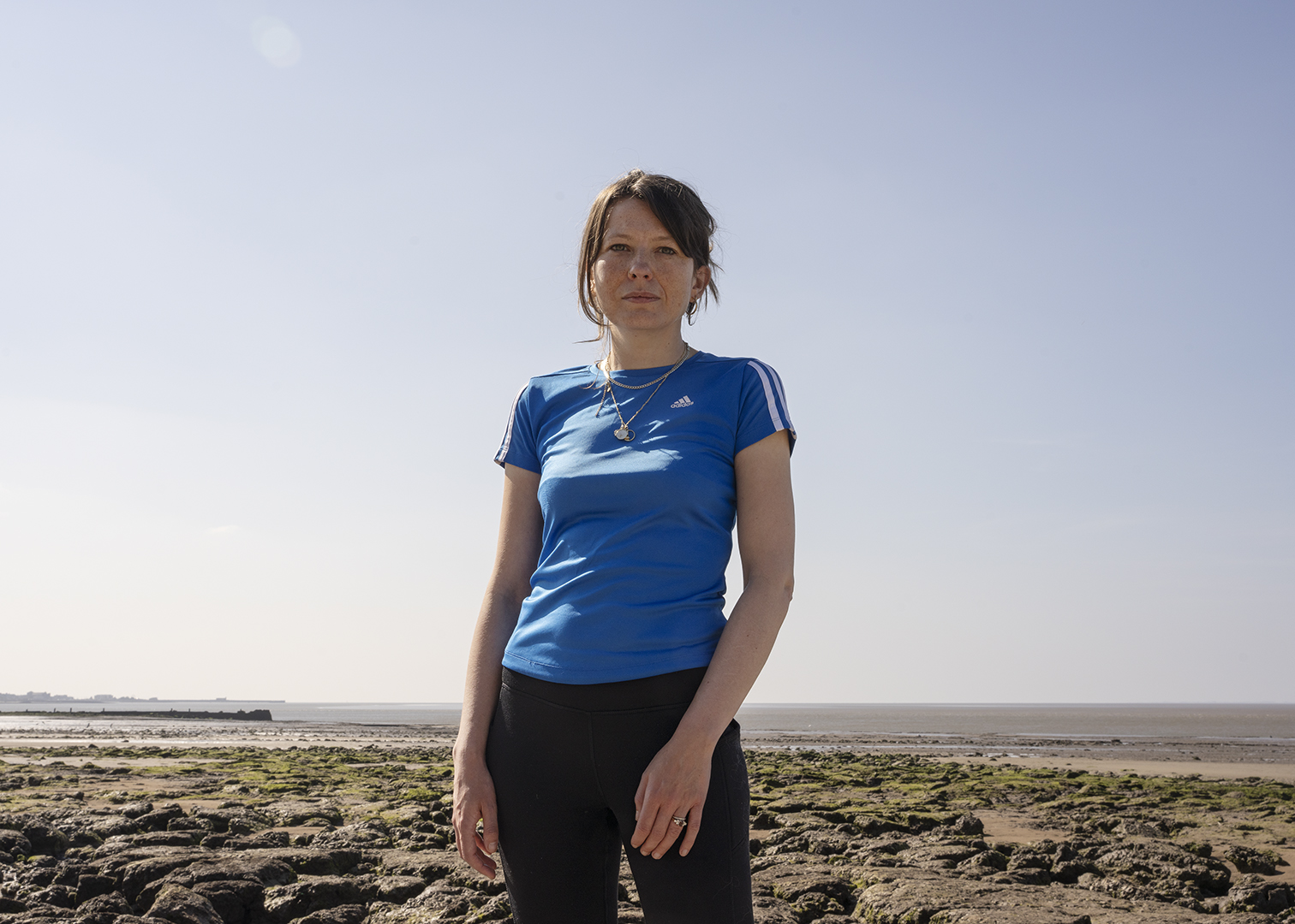 Image of author Jen Ashworth stood on a beach